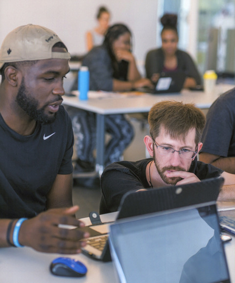 Andrew Judd, full-stack developer, coding with coffee at a community meetup